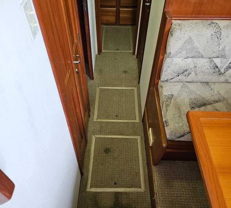 Slide: The Image of Interior hallway of a 1991 Viking 45 Convertible boat with carpeted flooring. - 18