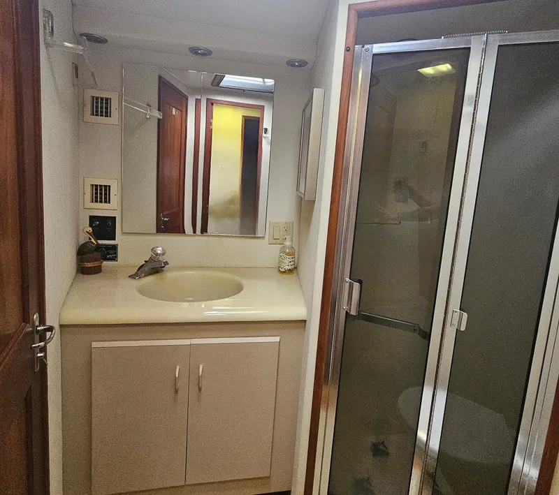 Slide: The Image of Bathroom interior of 1991 Viking 45 Convertible yacht with sink and shower. - 22