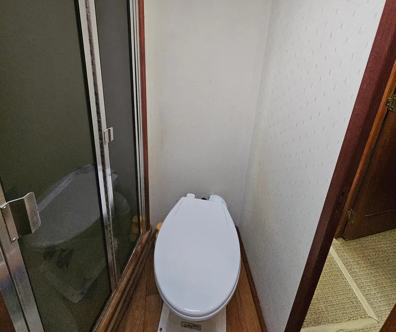 Slide: The Image of Bathroom interior of 1991 Viking 45 Convertible yacht with toilet and shower. - 23