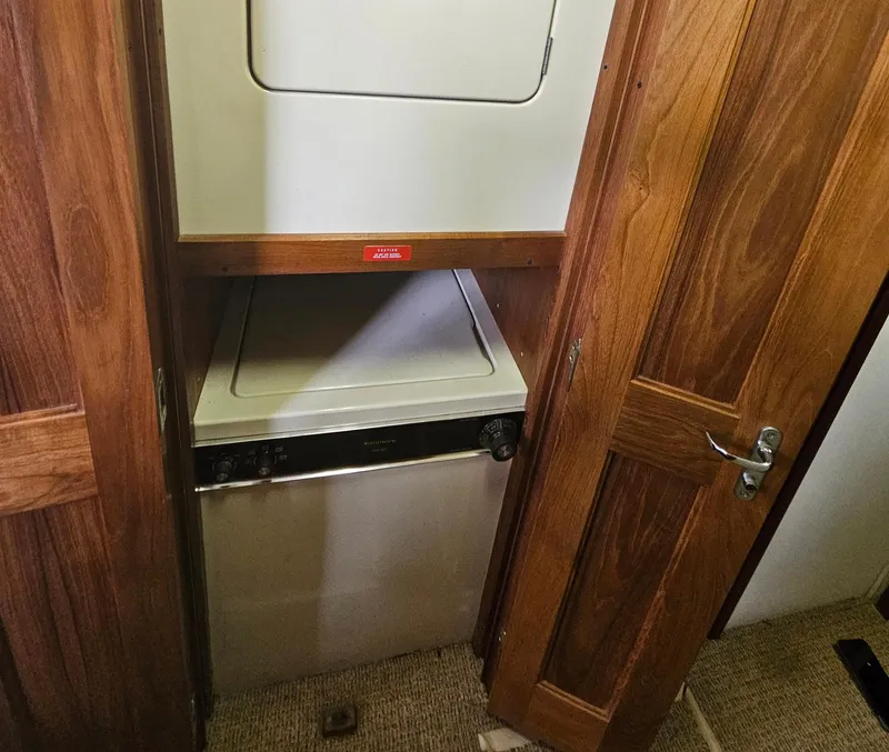 Slide: The Image of 1991 Viking 45 Convertible yacht interior with stacked washer and dryer unit. - 24