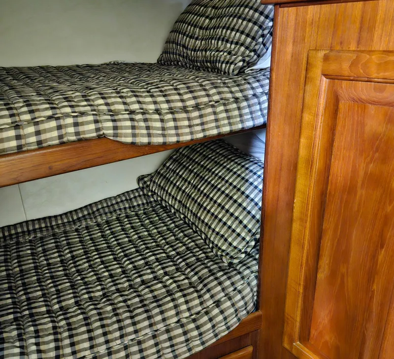 Slide: The Image of Bunk beds with checkered bedding in 1991 Viking 45 Convertible yacht interior. - 26