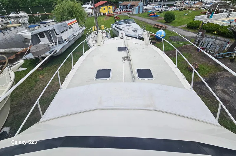 Slide: The Image of 1991 Viking 45 Convertible boat docked at a marina, surrounded by other vessels. - 29