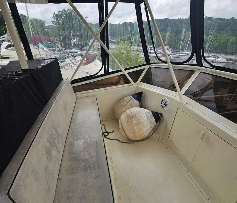 Slide: The Image of Interior of 1991 Viking 45 Convertible boat with seating and cushions, docked at marina. - 30