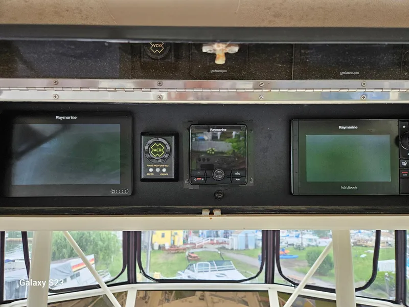 Slide: The Image of Control panel of a 1991 Viking 45 Convertible boat with navigation screens. - 33