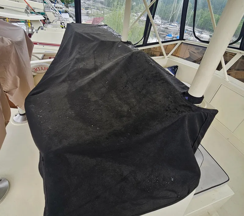 Slide: The Image of 1991 Viking 45 Convertible boat interior with black cover on equipment. - 36