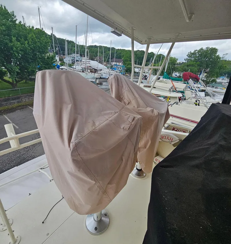 Slide: The Image of 1991 Viking 45 Convertible boat with covered seats, docked in a marina. - 38