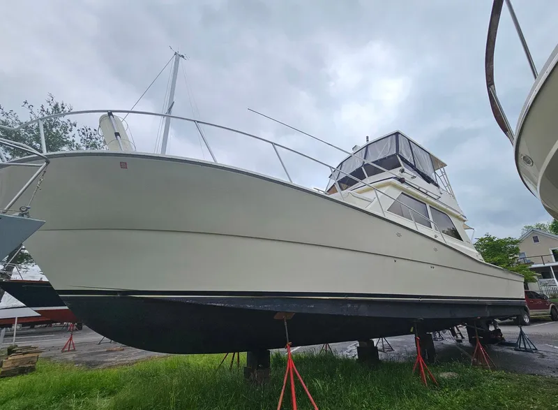Slide: The Image of 1991 Viking 45 Convertible boat on stands, cloudy sky background. - 44