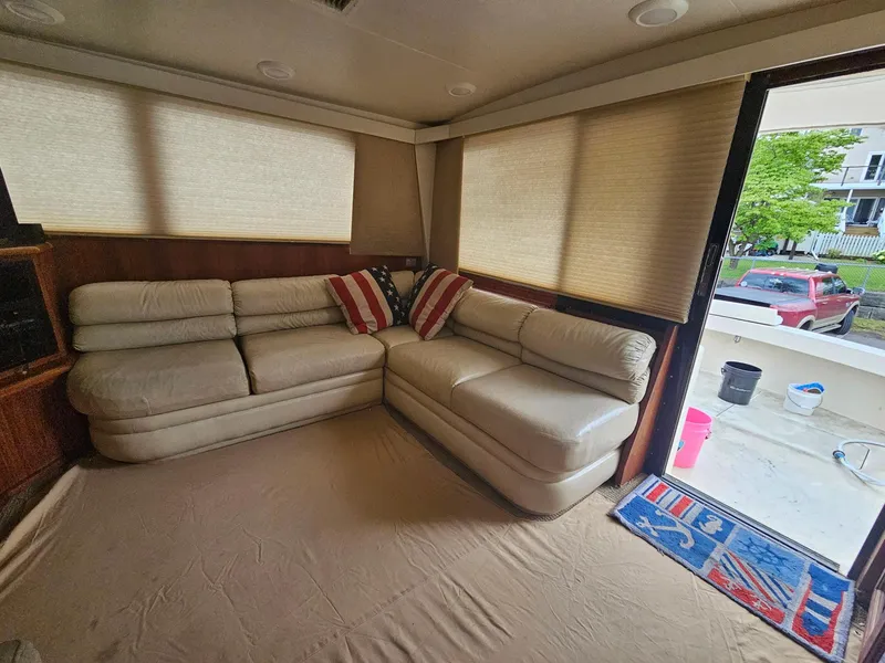 Slide: The Image of Interior of 1991 Viking 45 Convertible yacht with beige leather seating and striped cushions. - 7