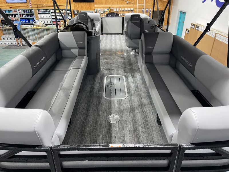 Slide: The Image of 2025 Bennington 25SSRSE pontoon boat interior with gray seating and modern design. - 13