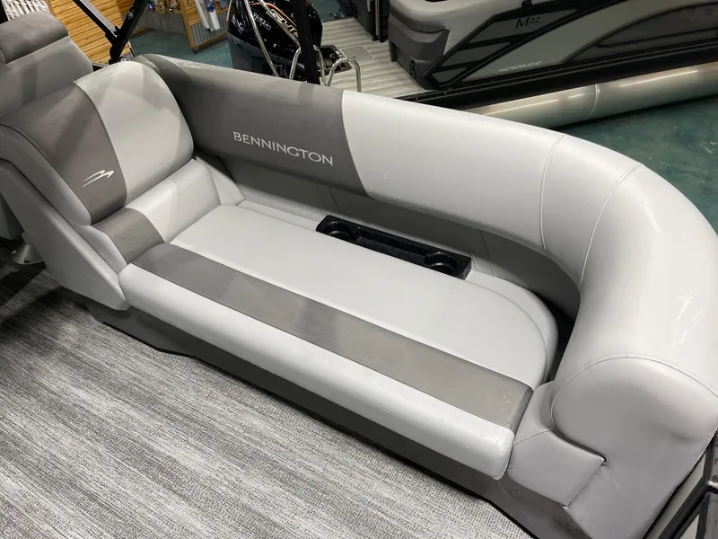 Slide: The Image of 2025 Bennington 25SSRSE boat interior with gray seating and logo. - 15