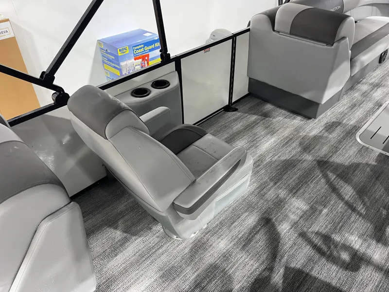Slide: The Image of Interior of 2025 Bennington 25SSRSE boat with gray seating and carpeted flooring. - 17