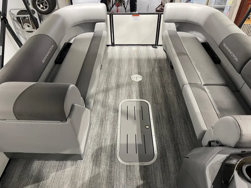 Slide: The Image of 2025 Bennington 25SSRSE pontoon boat interior with gray seating and carpeted flooring. - 18