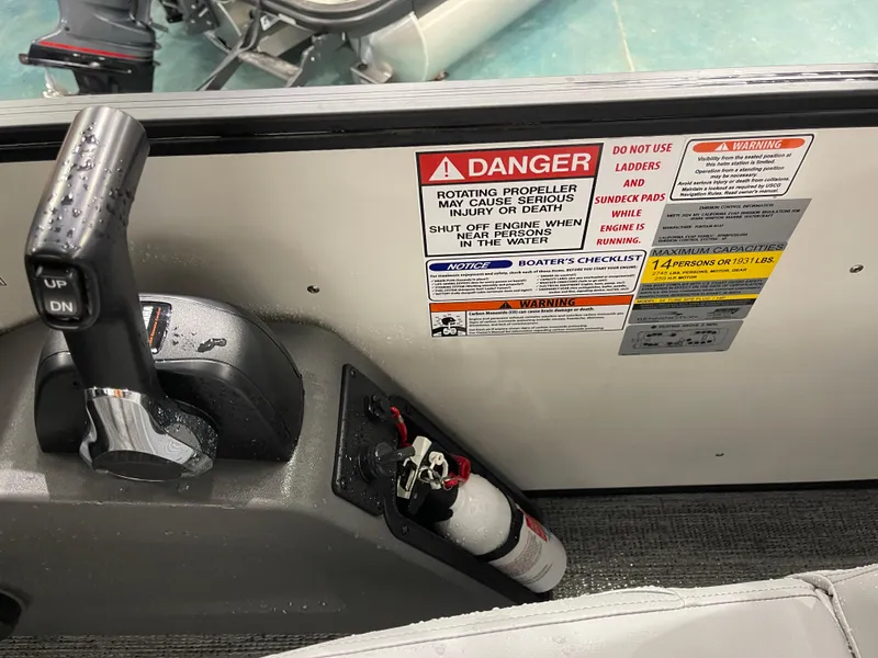 Slide: The Image of Control panel of 2025 Bennington 25SSRSE boat with safety warnings and fire extinguisher. - 20