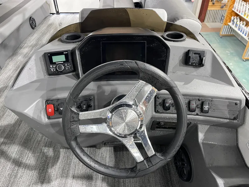 Slide: The Image of 2025 Bennington 25SSRSE boat dashboard with steering wheel and control panel. - 23