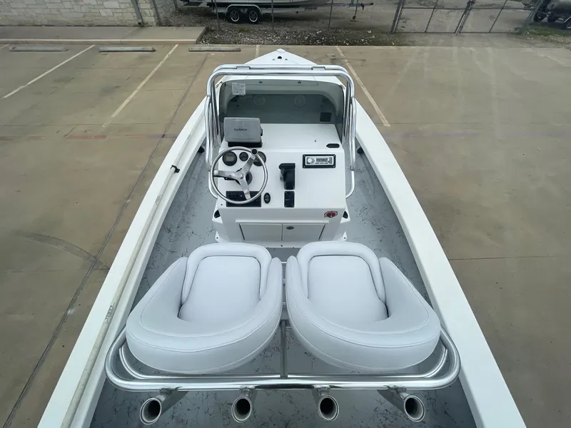 Slide: The Image of 2013 Majek 22 XTREME boat interior with steering console and white seating. - 16