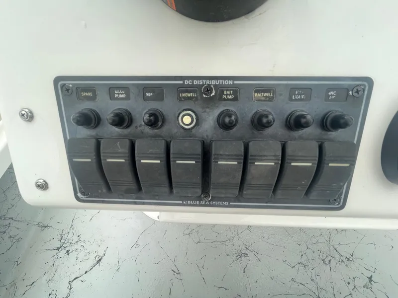 Slide: The Image of Control panel of a 2013 Majek 22 XTREME boat with various switches and labels. - 18