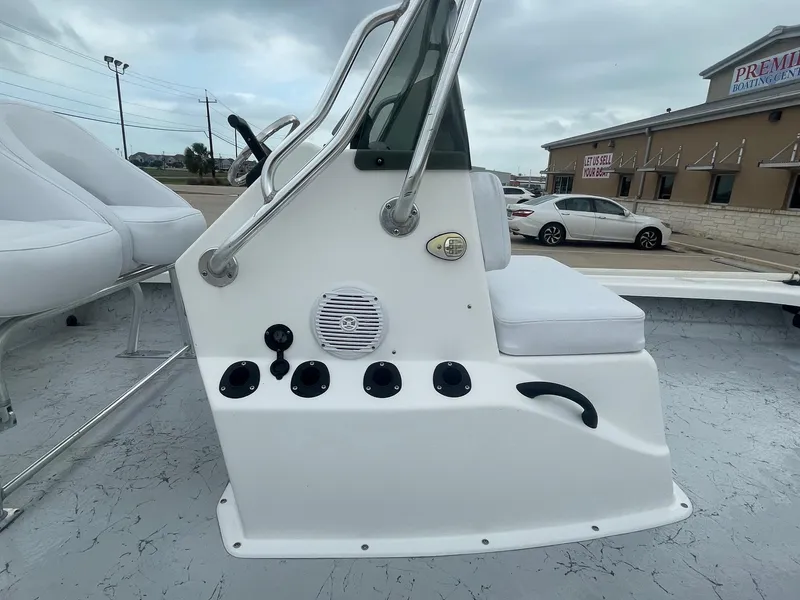 Slide: The Image of 2013 Majek 22 XTREME boat console with seating, speaker, and controls in a dealership lot. - 23