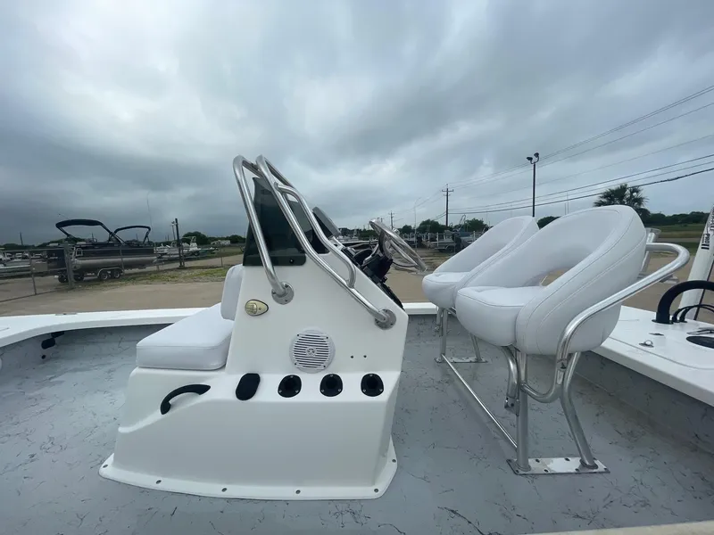 Slide: The Image of 2013 Majek 22 XTREME boat interior with white seating and steering console. - 24