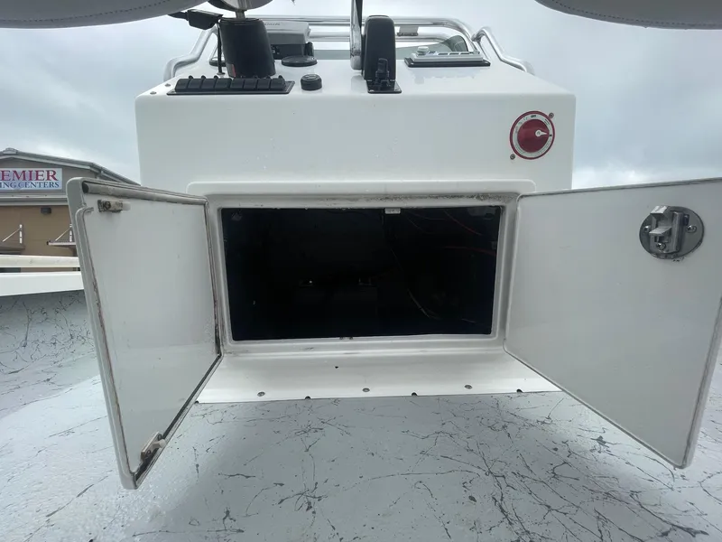 Slide: The Image of 2013 Majek 22 XTREME boat storage compartment with open doors, showcasing interior space. - 26