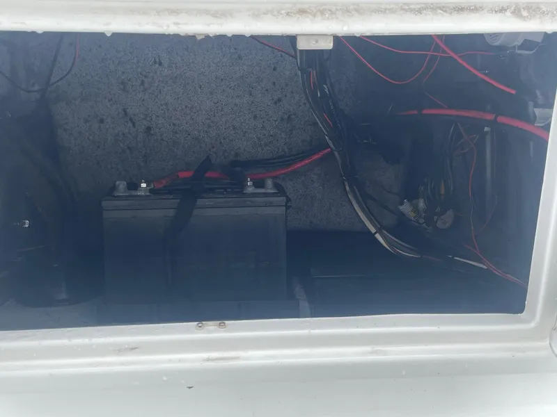 Slide: The Image of Battery compartment of a 2013 Majek 22 XTREME boat with visible wiring. - 27