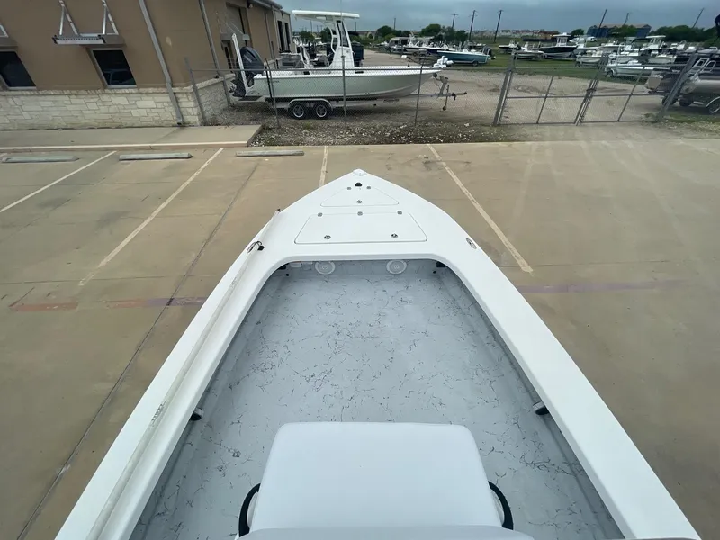 Slide: The Image of 2013 Majek 22 XTREME boat, top view, parked in a lot with other boats. - 28