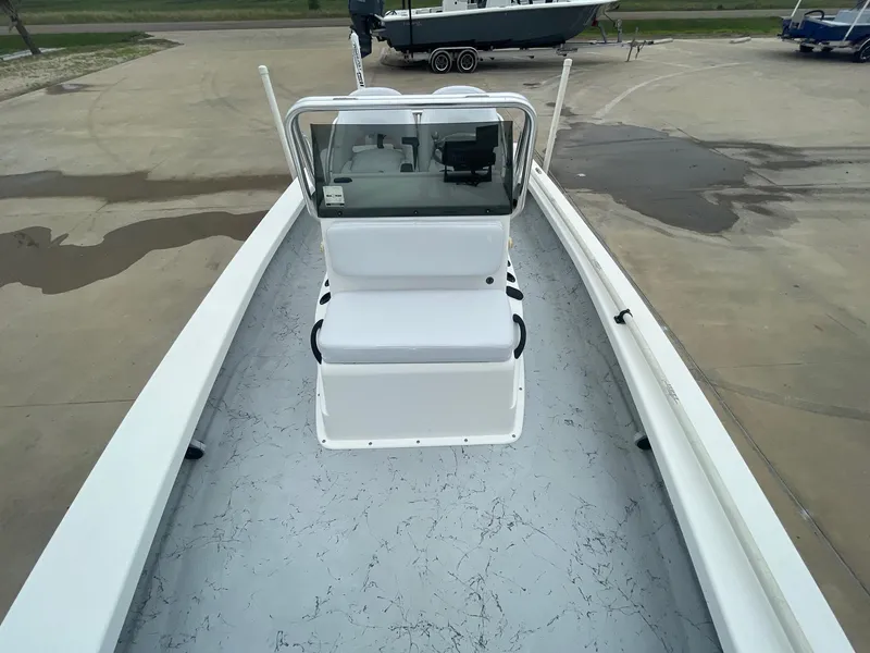 Slide: The Image of 2013 Majek 22 XTREME boat interior with white seating and spacious deck. - 29