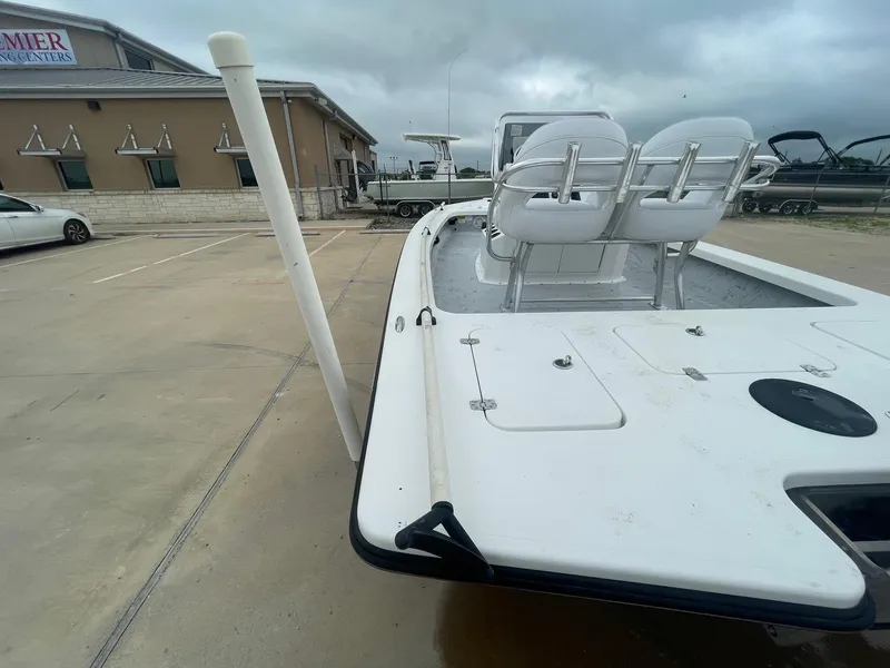 Slide: The Image of 2013 Majek 22 XTREME boat in parking lot, featuring dual seats and storage compartments. - 31