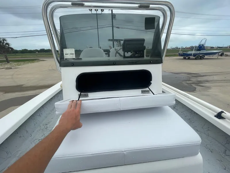 Slide: The Image of 2013 Majek 22 XTREME boat with open storage compartment and cushioned seating. - 33