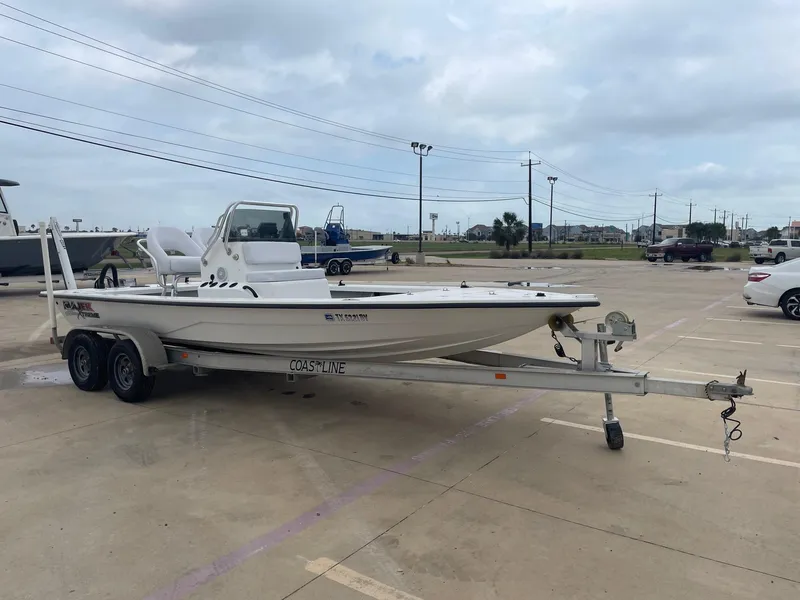 Slide: The Image of 2013 Majek 22 XTREME boat on trailer in parking lot, cloudy sky background. - 6