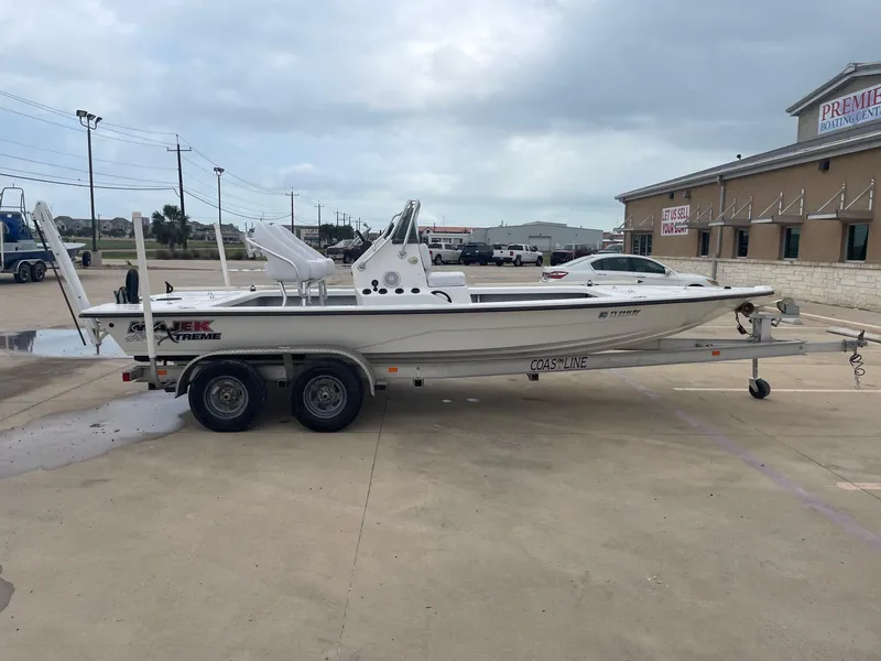 Slide: The Image of 2013 Majek 22 XTREME boat on trailer in parking lot, overcast sky. - 7