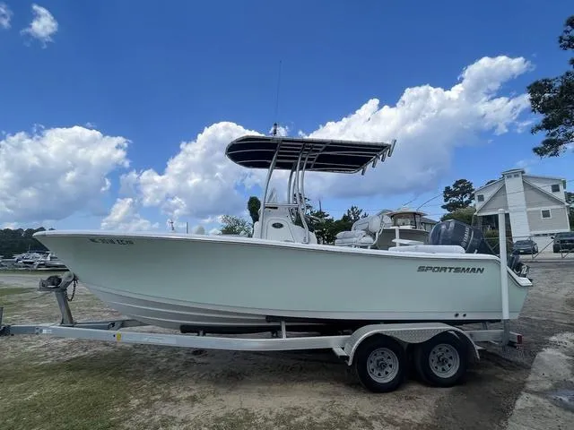 Slide: The Image of 2015 Sportsman Heritage 211 boat on trailer under blue sky with clouds. - 3