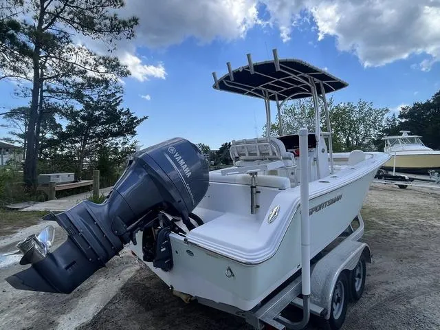 Slide: The Image of 2015 Sportsman Heritage 211 boat with Yamaha engine on trailer, parked outdoors. - 6