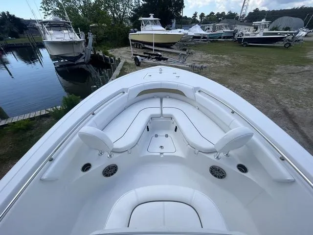 Slide: The Image of 2015 Sportsman Heritage 211 boat with spacious seating, docked near other boats. - 8