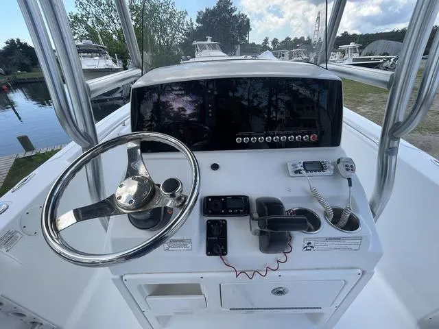 Slide: The Image of 2015 Sportsman Heritage 211 boat console with steering wheel and control panel. - 9
