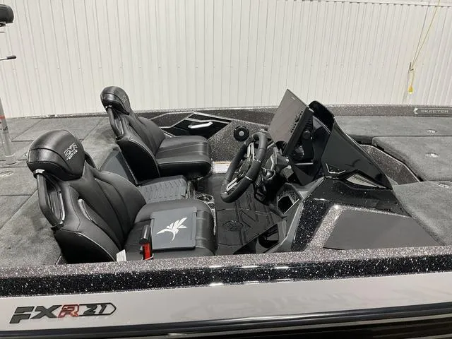 Slide: The Image of 2025 Skeeter FXR21L boat interior with sleek black seats and modern dashboard. - 10