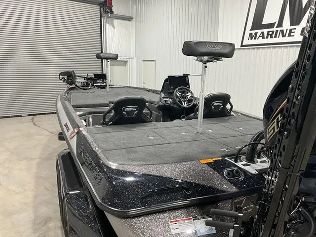 Slide: The Image of 2025 Skeeter FXR21L bass boat in showroom, featuring spacious deck and modern seating. - 11