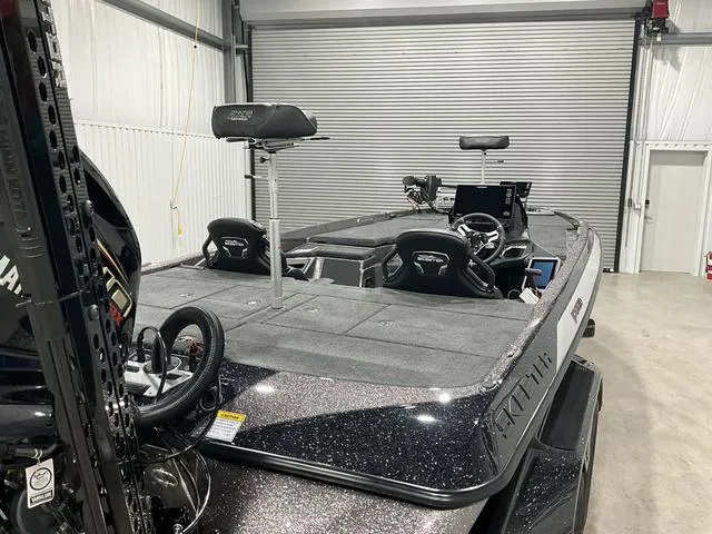 Slide: The Image of 2025 Skeeter FXR21L bass boat in a garage, showcasing sleek design and advanced features. - 12