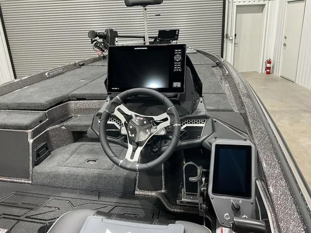 Slide: The Image of 2025 Skeeter FXR21L boat interior with advanced navigation system and steering wheel. - 13