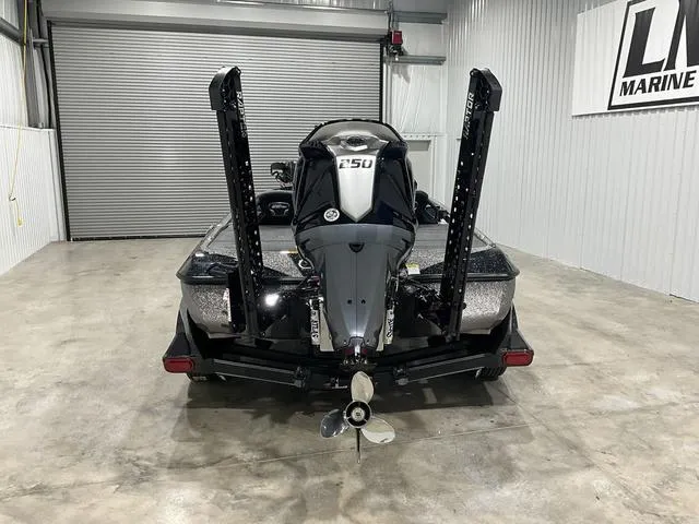 Slide: The Image of 2025 Skeeter FXR21L boat in garage, rear view with motor and propeller. - 3