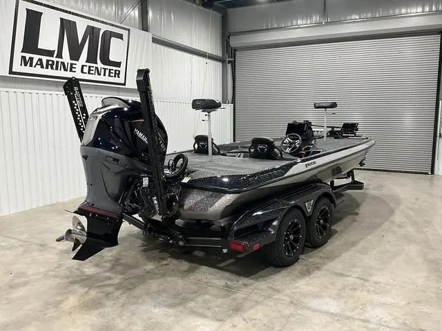 Slide: The Image of 2025 Skeeter FXR21L bass boat in showroom, featuring Yamaha outboard motor. - 7