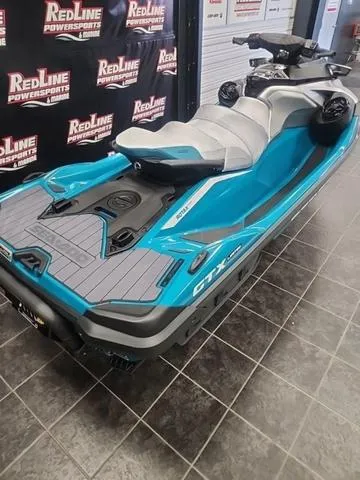Slide: The Image of 2025 Sea-Doo Waverunner GTX in showroom, featuring sleek design and vibrant blue color. - 10