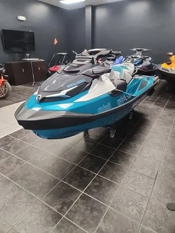 Slide: The Image of 2025 Sea-Doo Waverunner GTX in showroom, sleek design, vibrant blue and black colors. - 12