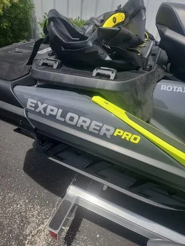 Slide: The Image of 2025 Sea-Doo Waverunner Explorer Pro, gray and yellow, parked on a trailer. - 16