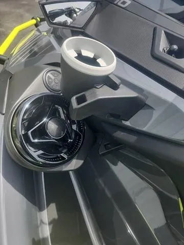 Slide: The Image of 2025 Sea-Doo Waverunner Explorer Pro dashboard with cup holder and speaker detail. - 24