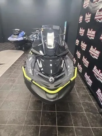 Slide: The Image of 2025 Sea-Doo Waverunner Explorer Pro on showroom floor, black and yellow design. - 8
