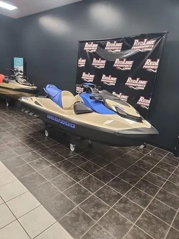 Slide: The Image of 2025 Sea-Doo Waverunner Wake™ 170 on display in showroom with RedLine backdrop. - 12