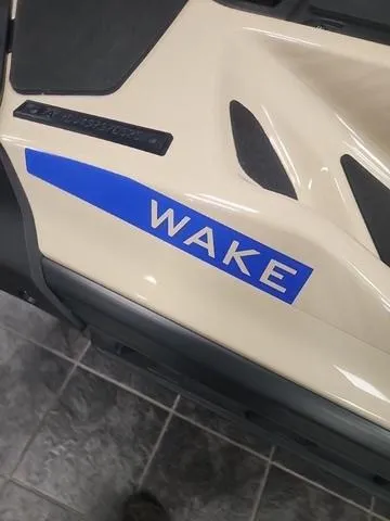 Slide: The Image of 2025 Sea-Doo Waverunner Wake 170 with blue decal on beige body. - 6