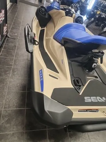 Slide: The Image of 2025 Sea-Doo Waverunner Wake™ 170 with blue seats, displayed indoors. - 8