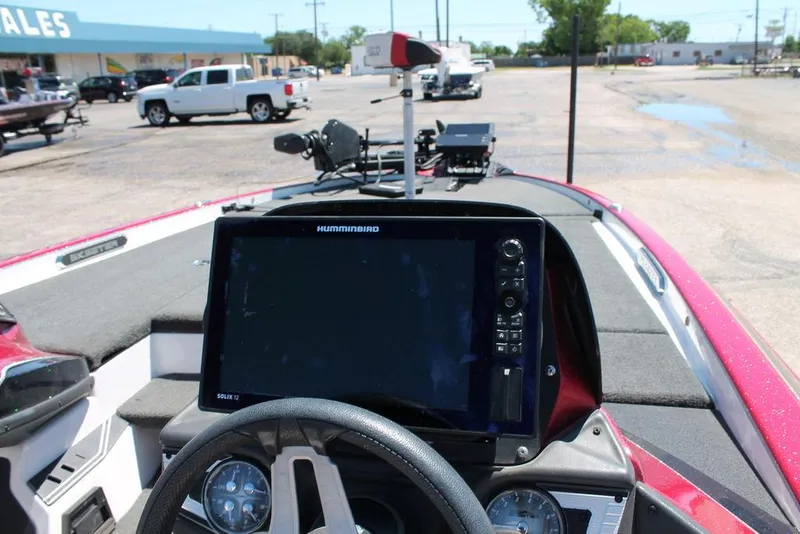 Slide: The Image of 2019 Skeeter FX21 LE boat dashboard with Humminbird electronics in a dealership lot. - 3