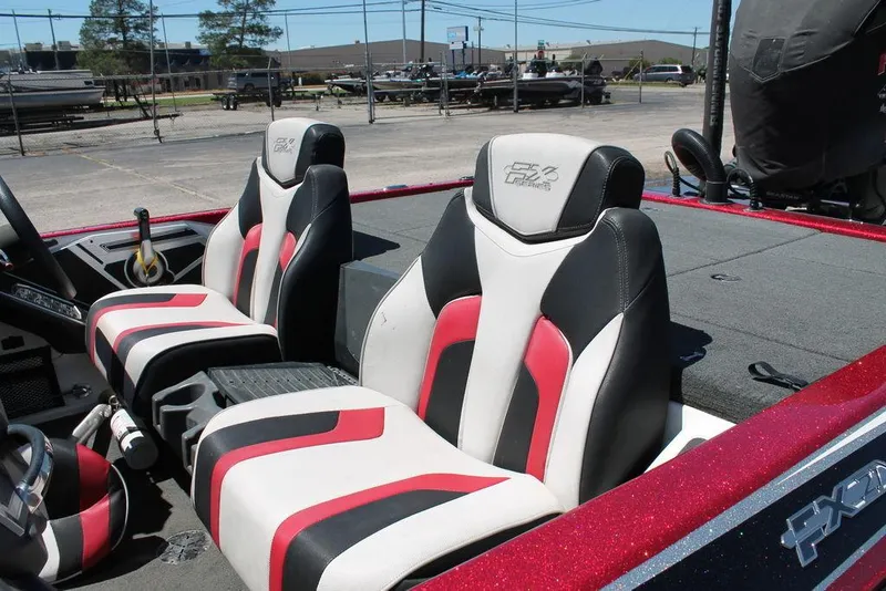 Slide: The Image of 2019 Skeeter FX21 LE boat interior with stylish red, black, and white seats. - 7